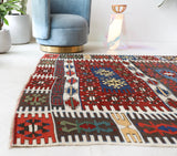 Vintage kilim rug in living room setting, bright colors, wild shaman, soft rug, bold color, Portland, Oregon, rug store, rug shop, local shop, vintage rug, modern kilim, warm colors, antique rug, antique kilim