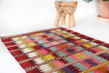 Vintage kilim rug in room decor setting, old rug, antique rug, pastel colors, faded colors, Turkish rug, vintage rug, soft rug, Portland, Oregon, rug store, rug shop, local shop,  antique kilim rug, bold colors, bright colors, faded colors