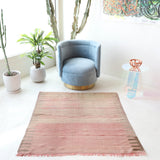 Vintage kilim rug in living room setting, old rug, antique rug, pastel colors, faded colors, Turkish rug, vintage rug, soft rug, Portland, Oregon, rug store, rug shop, local shop, earthy tones, earthy colors, warm colors