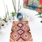 Vintage kilim rug in room decor setting, old rug, antique rug, pastel colors, faded colors, Turkish rug, vintage rug, soft rug, Portland, Oregon, rug store, rug shop, local shop,  antique kilim rug, bold colors, bright colors, faded colors