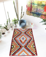 Vintage kilim rug in room decor setting, old rug, antique rug, pastel colors, faded colors, Turkish rug, vintage rug, soft rug, Portland, Oregon, rug store, rug shop, local shop,  antique kilim rug, bold colors, bright colors, faded colors