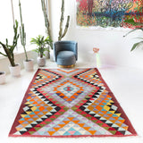 Vintage kilim rug in room decor setting, old rug, antique rug, pastel colors, faded colors, Turkish rug, vintage rug, soft rug, Portland, Oregon, rug store, rug shop, local shop,  antique kilim rug, bold colors, bright colors, faded colors