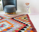 Vintage kilim rug in room decor setting, old rug, antique rug, pastel colors, faded colors, Turkish rug, vintage rug, soft rug, Portland, Oregon, rug store, rug shop, local shop,  antique kilim rug, bold colors, bright colors, faded colors