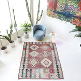 Vintage kilim rug in room decor setting, old rug, antique rug, pastel colors, faded colors, Turkish rug, vintage rug, soft rug, Portland, Oregon, rug store, rug shop, local shop,  antique kilim rug, bold colors, bright colors, faded colors