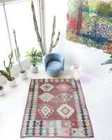 Vintage kilim rug in room decor setting, old rug, antique rug, pastel colors, faded colors, Turkish rug, vintage rug, soft rug, Portland, Oregon, rug store, rug shop, local shop,  antique kilim rug, bold colors, bright colors, faded colors