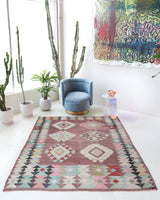 Vintage kilim rug in room decor setting, old rug, antique rug, pastel colors, faded colors, Turkish rug, vintage rug, soft rug, Portland, Oregon, rug store, rug shop, local shop,  antique kilim rug, bold colors, bright colors, faded colors