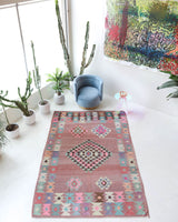 Vintage kilim rug in room decor setting, old rug, antique rug, pastel colors, faded colors, Turkish rug, vintage rug, soft rug, Portland, Oregon, rug store, rug shop, local shop,  antique kilim rug, bold colors, bright colors, faded colors