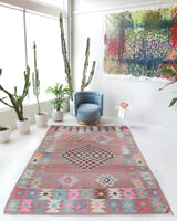 Vintage kilim rug in room decor setting, old rug, antique rug, pastel colors, faded colors, Turkish rug, vintage rug, soft rug, Portland, Oregon, rug store, rug shop, local shop,  antique kilim rug, bold colors, bright colors, faded colors