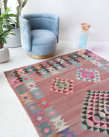 Vintage kilim rug in room decor setting, old rug, antique rug, pastel colors, faded colors, Turkish rug, vintage rug, soft rug, Portland, Oregon, rug store, rug shop, local shop,  antique kilim rug, bold colors, bright colors, faded colors