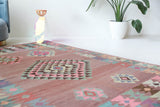 Vintage kilim rug in room decor setting, old rug, antique rug, pastel colors, faded colors, Turkish rug, vintage rug, soft rug, Portland, Oregon, rug store, rug shop, local shop,  antique kilim rug, bold colors, bright colors, faded colors