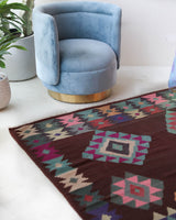 Vintage kilim rug in room decor setting, old rug, antique rug, pastel colors, faded colors, Turkish rug, vintage rug, soft rug, Portland, Oregon, rug store, rug shop, local shop,  antique kilim rug, bold colors, bright colors, faded colors