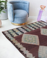 Vintage kilim rug in room decor setting, old rug, antique rug, pastel colors, faded colors, Turkish rug, vintage rug, soft rug, Portland, Oregon, rug store, rug shop, local shop,  antique kilim rug, bold colors, bright colors, faded colors