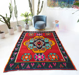 Vintage kilim rug in living room setting, bright colors, wild shaman, soft rug, bold color, Portland, Oregon, rug store, rug shop, local shop, vintage rug, modern kilim, warm colors, antique rug, antique kilim