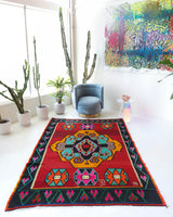 Vintage kilim rug in living room setting, bright colors, wild shaman, soft rug, bold color, Portland, Oregon, rug store, rug shop, local shop, vintage rug, modern kilim, warm colors, antique rug, antique kilim