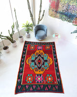 Vintage kilim rug in living room setting, bright colors, wild shaman, soft rug, bold color, Portland, Oregon, rug store, rug shop, local shop, vintage rug, modern kilim, warm colors, antique rug, antique kilim