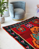 Vintage kilim rug in living room setting, bright colors, wild shaman, soft rug, bold color, Portland, Oregon, rug store, rug shop, local shop, vintage rug, modern kilim, warm colors, antique rug, antique kilim