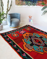Vintage kilim rug in living room setting, bright colors, wild shaman, soft rug, bold color, Portland, Oregon, rug store, rug shop, local shop, vintage rug, modern kilim, warm colors, antique rug, antique kilim