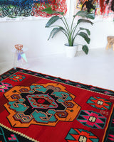 Vintage kilim rug in living room setting, bright colors, wild shaman, soft rug, bold color, Portland, Oregon, rug store, rug shop, local shop, vintage rug, modern kilim, warm colors, antique rug, antique kilim