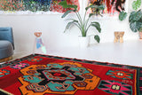 Vintage kilim rug in living room setting, bright colors, wild shaman, soft rug, bold color, Portland, Oregon, rug store, rug shop, local shop, vintage rug, modern kilim, warm colors, antique rug, antique kilim