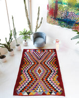 Vintage kilim rug in living room setting, bright colors, wild shaman, soft rug, bold color, Portland, Oregon, rug store, rug shop, local shop, vintage rug, modern kilim, warm colors, antique rug, antique kilim