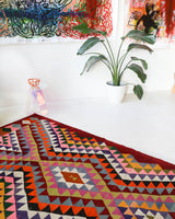 Vintage kilim rug in living room setting, bright colors, wild shaman, soft rug, bold color, Portland, Oregon, rug store, rug shop, local shop, vintage rug, modern kilim, warm colors, antique rug, antique kilim