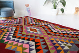 Vintage kilim rug in living room setting, bright colors, wild shaman, soft rug, bold color, Portland, Oregon, rug store, rug shop, local shop, vintage rug, modern kilim, warm colors, antique rug, antique kilim