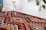 Vintage kilim rug in living room setting, bright colors, wild shaman, soft rug, bold color, Portland, Oregon, rug store, rug shop, local shop, vintage rug, modern kilim, warm colors, antique rug, antique kilim