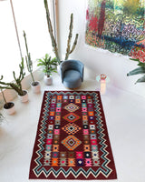 Vintage kilim rug in living room setting, bright colors, wild shaman, soft rug, bold color, Portland, Oregon, rug store, rug shop, local shop, vintage rug, modern kilim, warm colors, antique rug, antique kilim