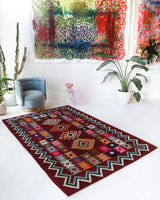 Vintage kilim rug in living room setting, bright colors, wild shaman, soft rug, bold color, Portland, Oregon, rug store, rug shop, local shop, vintage rug, modern kilim, warm colors, antique rug, antique kilim