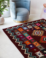 Vintage kilim rug in living room setting, bright colors, wild shaman, soft rug, bold color, Portland, Oregon, rug store, rug shop, local shop, vintage rug, modern kilim, warm colors, antique rug, antique kilim
