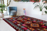 Vintage kilim rug in living room setting, bright colors, wild shaman, soft rug, bold color, Portland, Oregon, rug store, rug shop, local shop, vintage rug, modern kilim, warm colors, antique rug, antique kilim