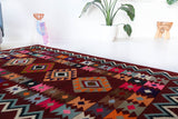 Vintage kilim rug in living room setting, bright colors, wild shaman, soft rug, bold color, Portland, Oregon, rug store, rug shop, local shop, vintage rug, modern kilim, warm colors, antique rug, antique kilim