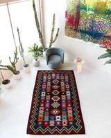 Vintage kilim rug in living room setting, bright colors, wild shaman, soft rug, bold color, Portland, Oregon, rug store, rug shop, local shop, vintage rug, modern kilim, warm colors, antique rug, antique kilim