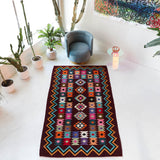 Vintage kilim rug in living room setting, bright colors, wild shaman, soft rug, bold color, Portland, Oregon, rug store, rug shop, local shop, vintage rug, modern kilim, warm colors, antique rug, antique kilim