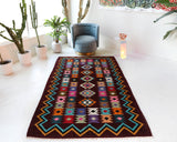 Vintage kilim rug in living room setting, bright colors, wild shaman, soft rug, bold color, Portland, Oregon, rug store, rug shop, local shop, vintage rug, modern kilim, warm colors, antique rug, antique kilim