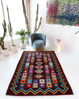Vintage kilim rug in living room setting, bright colors, wild shaman, soft rug, bold color, Portland, Oregon, rug store, rug shop, local shop, vintage rug, modern kilim, warm colors, antique rug, antique kilim