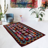 Vintage kilim rug in living room setting, bright colors, wild shaman, soft rug, bold color, Portland, Oregon, rug store, rug shop, local shop, vintage rug, modern kilim, warm colors, antique rug, antique kilim