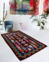 Vintage kilim rug in living room setting, bright colors, wild shaman, soft rug, bold color, Portland, Oregon, rug store, rug shop, local shop, vintage rug, modern kilim, warm colors, antique rug, antique kilim