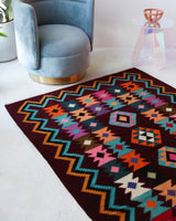 Vintage kilim rug in living room setting, bright colors, wild shaman, soft rug, bold color, Portland, Oregon, rug store, rug shop, local shop, vintage rug, modern kilim, warm colors, antique rug, antique kilim