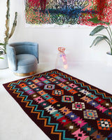 Vintage kilim rug in living room setting, bright colors, wild shaman, soft rug, bold color, Portland, Oregon, rug store, rug shop, local shop, vintage rug, modern kilim, warm colors, antique rug, antique kilim