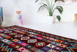 Vintage kilim rug in living room setting, bright colors, wild shaman, soft rug, bold color, Portland, Oregon, rug store, rug shop, local shop, vintage rug, modern kilim, warm colors, antique rug, antique kilim