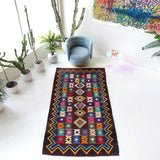 Vintage kilim rug in living room setting, bright colors, wild shaman, soft rug, bold color, Portland, Oregon, rug store, rug shop, local shop, vintage rug, modern kilim, warm colors, antique rug, antique kilim