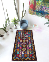 Vintage kilim rug in living room setting, bright colors, wild shaman, soft rug, bold color, Portland, Oregon, rug store, rug shop, local shop, vintage rug, modern kilim, warm colors, antique rug, antique kilim
