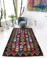 Vintage kilim rug in living room setting, bright colors, wild shaman, soft rug, bold color, Portland, Oregon, rug store, rug shop, local shop, vintage rug, modern kilim, warm colors, antique rug, antique kilim