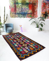 Vintage kilim rug in living room setting, bright colors, wild shaman, soft rug, bold color, Portland, Oregon, rug store, rug shop, local shop, vintage rug, modern kilim, warm colors, antique rug, antique kilim