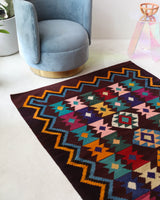 Vintage kilim rug in living room setting, bright colors, wild shaman, soft rug, bold color, Portland, Oregon, rug store, rug shop, local shop, vintage rug, modern kilim, warm colors, antique rug, antique kilim
