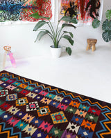 Vintage kilim rug in living room setting, bright colors, wild shaman, soft rug, bold color, Portland, Oregon, rug store, rug shop, local shop, vintage rug, modern kilim, warm colors, antique rug, antique kilim