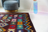 Vintage kilim rug in living room setting, bright colors, wild shaman, soft rug, bold color, Portland, Oregon, rug store, rug shop, local shop, vintage rug, modern kilim, warm colors, antique rug, antique kilim