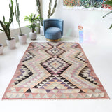 Vintage kilim rug in living room setting, old rug, antique rug, pastel colors, faded colors, Turkish rug, vintage rug, soft rug, Portland, Oregon, rug store, rug shop, local shop, earthy tones, earthy colors, warm colors
