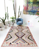 Vintage kilim rug in living room setting, old rug, antique rug, pastel colors, faded colors, Turkish rug, vintage rug, soft rug, Portland, Oregon, rug store, rug shop, local shop, earthy tones, earthy colors, warm colors